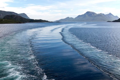 Wake of Hurtigruten ferry ship in water of Raftsundet strait of Hinnoya Island, Nordland, northern