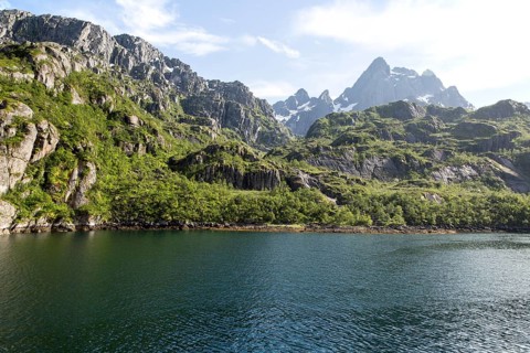 Steep sided glacial trough fiord jagged mountain peaks, Trollfjorden, Lofoten Islands, Nordland,