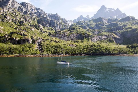 Steep sided glacial trough fiord jagged mountain peaks, Trollfjorden, Lofoten Islands, Nordland,