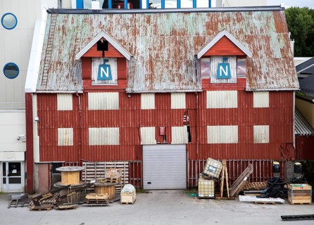 Old corrugated iron warehouse waterside building, Bronnoy, Bronnoysund, Nordland, Norway, Europe