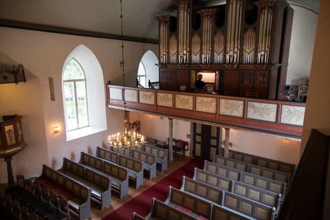 Organist playing inside Bronnoy Church, Bronnoysund, Nordland, Norway built in 1870