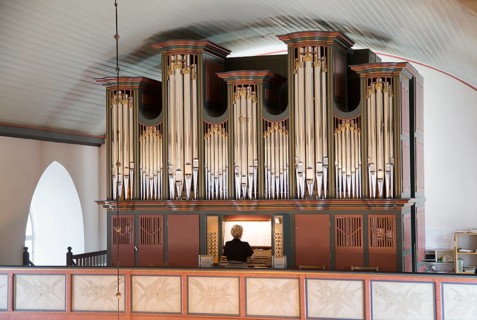 Organist playing inside Bronnoy Church, Bronnoysund, Nordland, Norway built in 1870