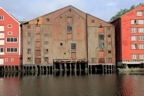 Historic waterside warehouse buildings on River Nidelva, Bryggene, Trondheim, Norway, Europe