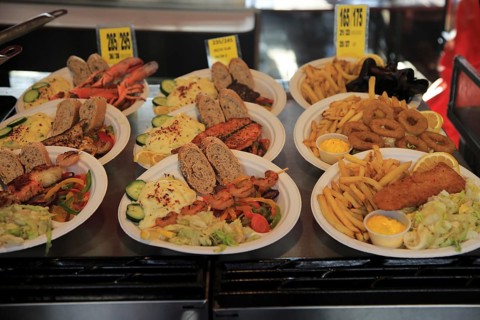 Sample street stall restaurant display fish meals in Torget market, Bergen, Norway, Europe