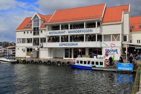 Waterside buildings and boats Vagen harbour, by Torget fish market, Bergen, Norway, Europe