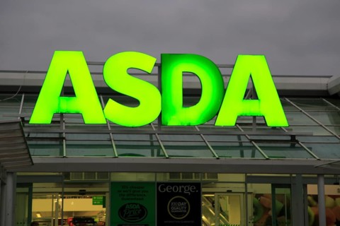 Asda superstore sign lit up at night, Falmouth, Cornwall, UK