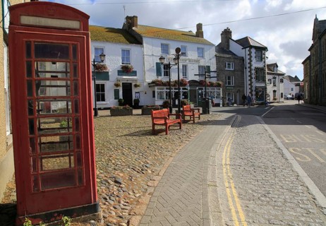 Traditional red telephone kiosk box in village square, Marazion Cornwall, England, UK