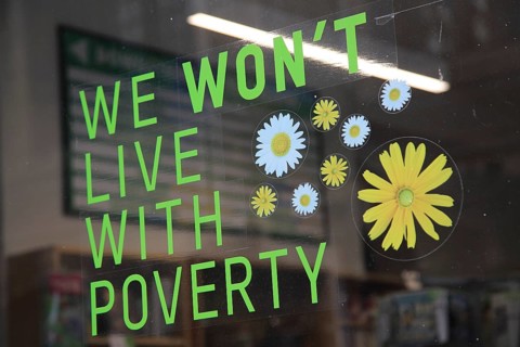 Anti-poverty message in Oxfam shop window, Oxford, England, UK