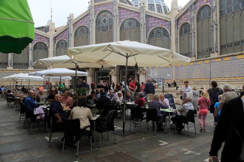 Street cafe tables outside central market building, city of Valencia, Spain, Europe