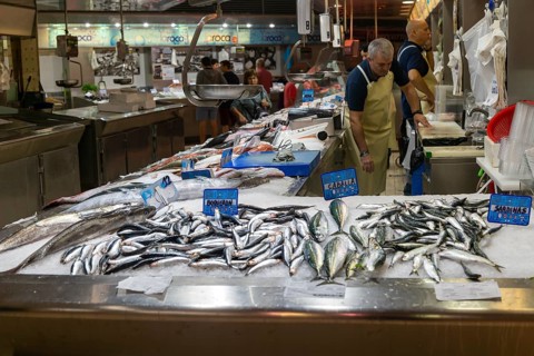 Food stall fishmonger selling fish inside central market building, city of Valencia, Spain, Europe