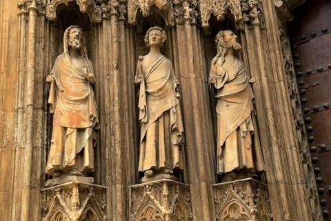 Statues of Christian saints carved stonework of the cathedral church in city of Valencia, Spain,
