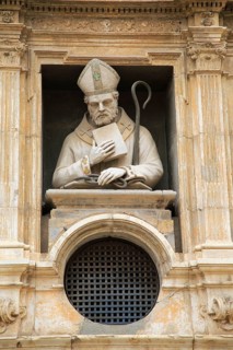 Statue of Christian bishop carved stonework of the cathedral church building in city of Valencia,