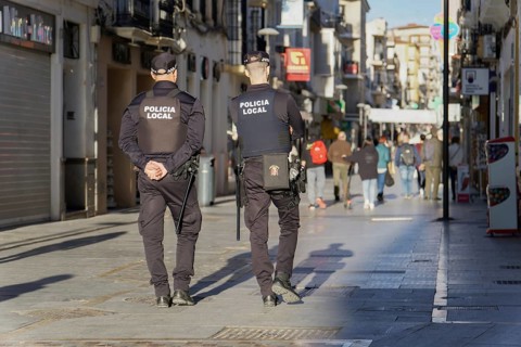 01, 22, 2024 ronda, malaga, spain Two unrecognizable policemen seen with their backs turned