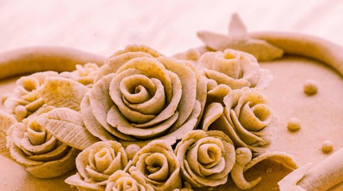 Closeup of rose patterns beige dough sculpture, Teig, gebacken