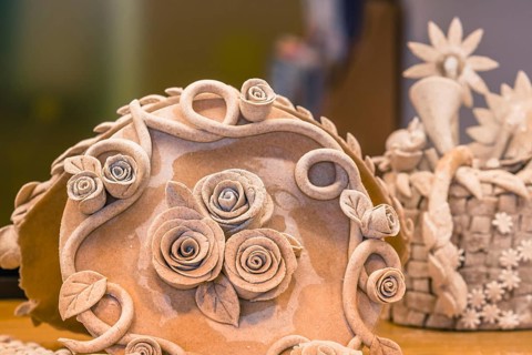 Closeup of rose patterns beige dough sculpture, Teig, gebacken