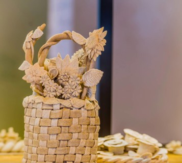Intricate bread basket adorned with detailed flowers and leaves