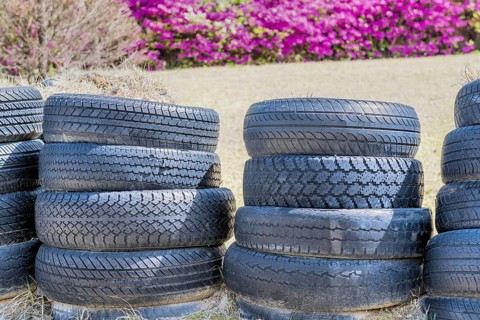 Stacks of old used tires in park with blurred background in Goseong, South Korea, Asia