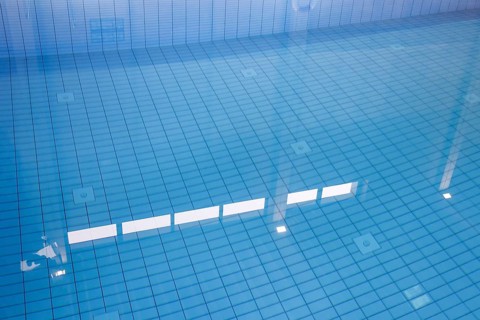 Lamps reflected in the swimming pool of the reopened Tiergarten municipal swimming pool, Berlin,
