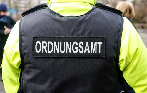An employee of the bicycle squadron of the public order office wears a protective waistcoat,