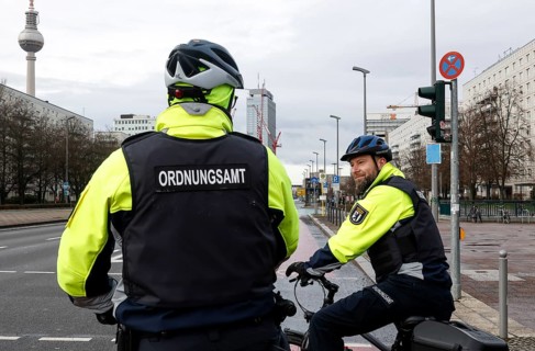 Employees of the bicycle squadron of the public order office with their bikes on a street. The