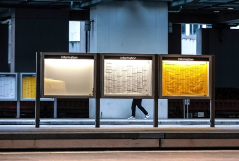 A man walks behind information boards at Südkreuz station. The fourth train drivers' strike by the