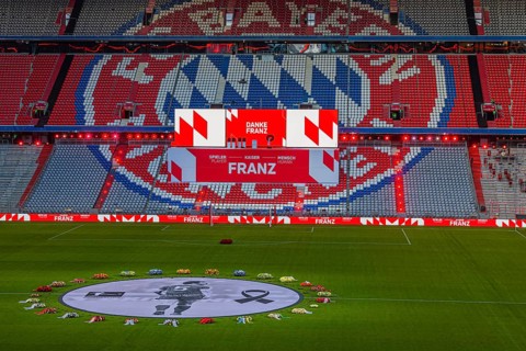Banner with Franz Beckenbauer and flower wreaths, behind the speaker's stage at the end of the