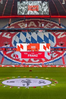 Banner with Franz Beckenbauer and wreaths of flowers, behind the speaker's stage at the end of the