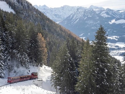 Winter landscape, Schafberg cog railway decorated for Christmas travelling up to the Schafbergalm,
