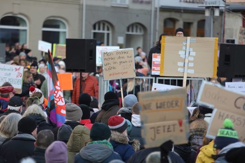 A set of anti AFD signs held high by members of the crowd during a demonstration against the AFD