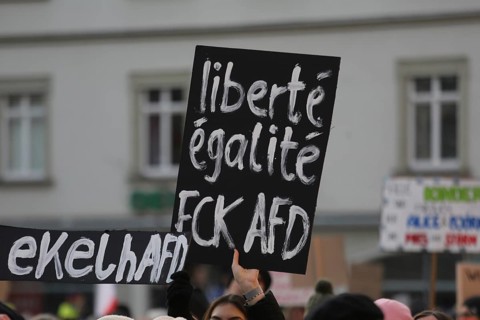 A placard to freedom and equality held high by a member of the crowd during a demonstration against