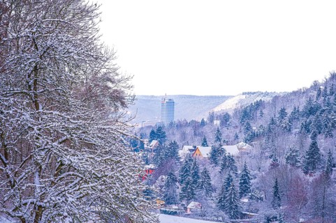 View of the snow-covered Jentower in Jena with mountains and forests in the background, Jena,