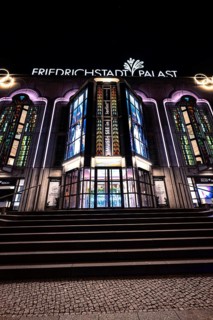 Night view of the illuminated Friedrichstadt-Palast with its characteristic façade and windows,