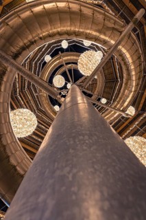 View upwards along an illuminated pillar with balls of light, magical forest dwellers, treetop walk