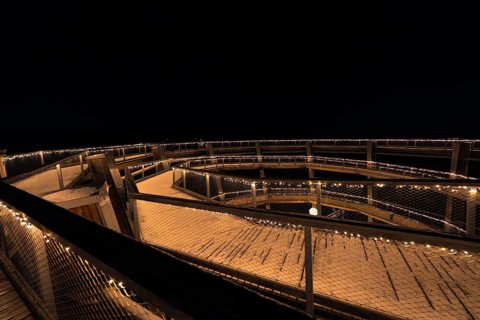 View over a round viewing platform illuminated at night, enchanting forest dwellers, Bad Wildbad