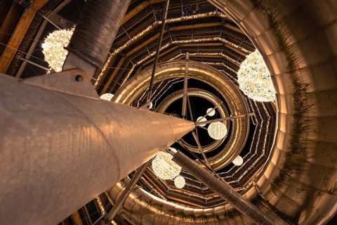 View upwards through a spiral-shaped wooden structure with light spheres, magical forest dwellers,