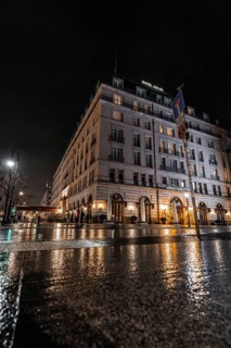 Night view of an elegant hotel with wet streets and atmospheric lighting, Hotel Adlon, Berlin,