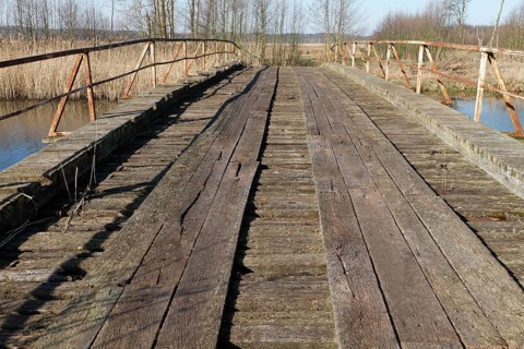 Dilapidated infrastructure on the River Trebel, old dilapidated bridge over the River Trebel,