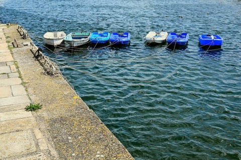 Row of small boats in the harbour basin, Concarneau, Finistère, Brittany, France, Europe