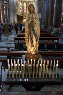 Electric candles in front of a Madonna in the Cathedral of San Lorenzo, Piazza San Lorenzo, Genoa,