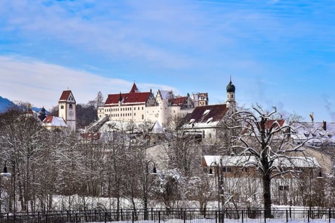 The Gothic High Castle of the Bishops of Augsburg in Füssen in winter, on the right the church of
