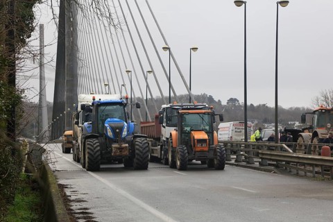 Farmers with tractors, craftsmen with vans and lorry drivers block the closed bridge Pont de