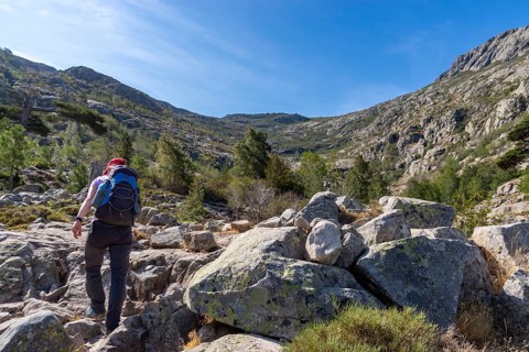 Woman hiking in the mountains, ascent to Lac de Nino, Corsica, France, Europe