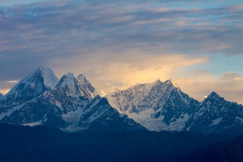 Langtang Himal, under the fairly cloudy sky, lit by the early-morning light, seen at sunrise on a