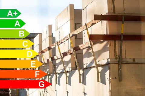 Construction site of a new housing estate, graphic with energy efficiency classes for buildings