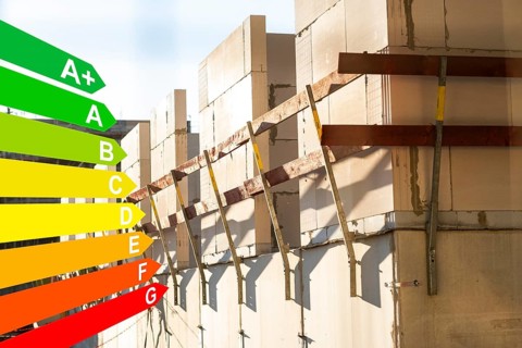 Construction site of a new housing estate, graphic with energy efficiency classes for buildings