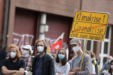 Demonstrators with a sign saying Climate Crisis at the alliance demo on climate racism and climate