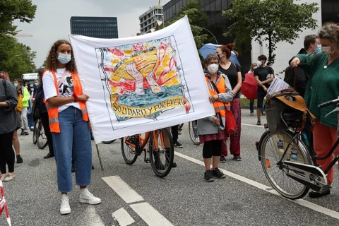 Demonstrators hold a banner with the inscription Solidarity forever at the alliance demonstration