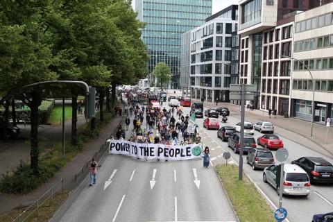 Demonstrators hold a banner with the inscription Power to the people at the alliance demo on