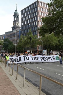 Demonstrators hold a banner with the inscription Power to the people at the alliance demo on