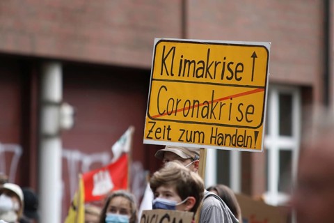 Demonstrators with a sign saying Climate Crisis at the alliance demo on climate racism and climate